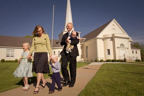 family leaving a Church meetinghouse