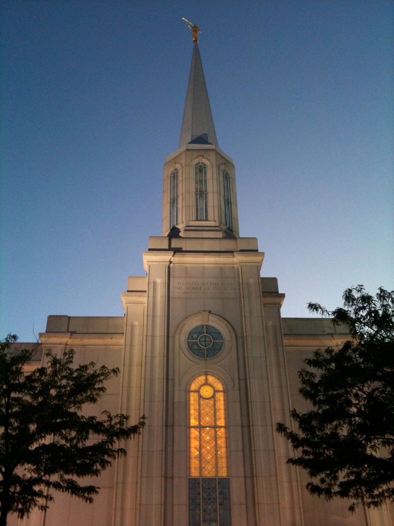 The St. Louis Missouri Temple in the evening, including the windows and spire.  