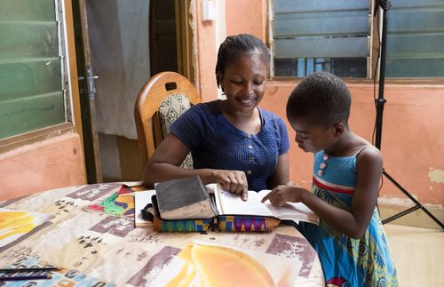 mother and daughter looking at a book