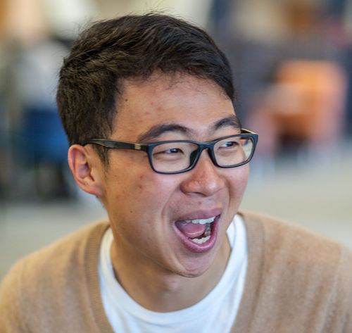 man with glasses laughing