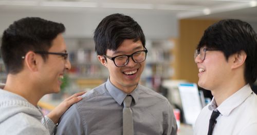 three young adults talking