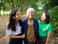 young women visiting elderly woman
