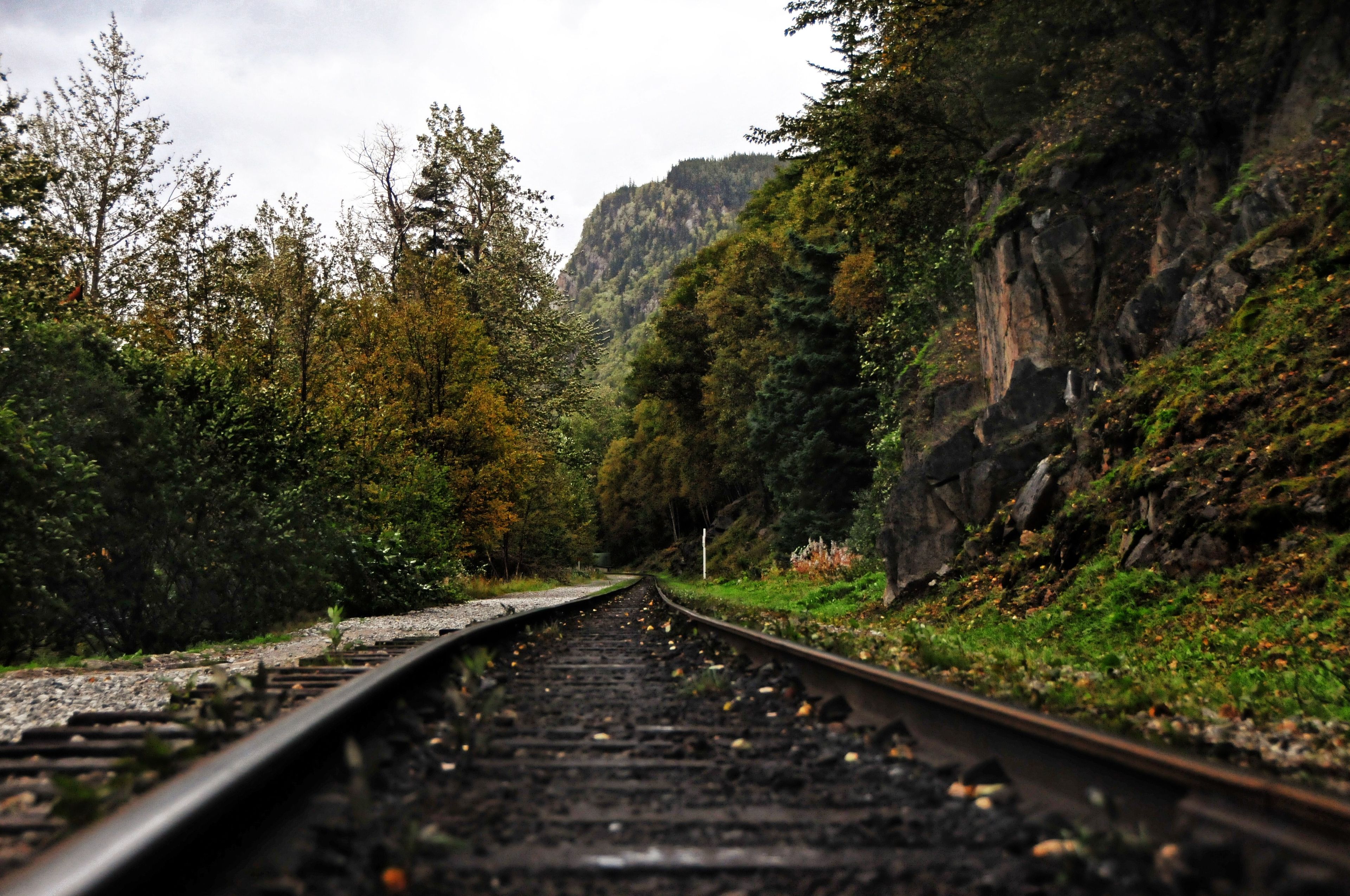 A railroad track that runs through mountains.