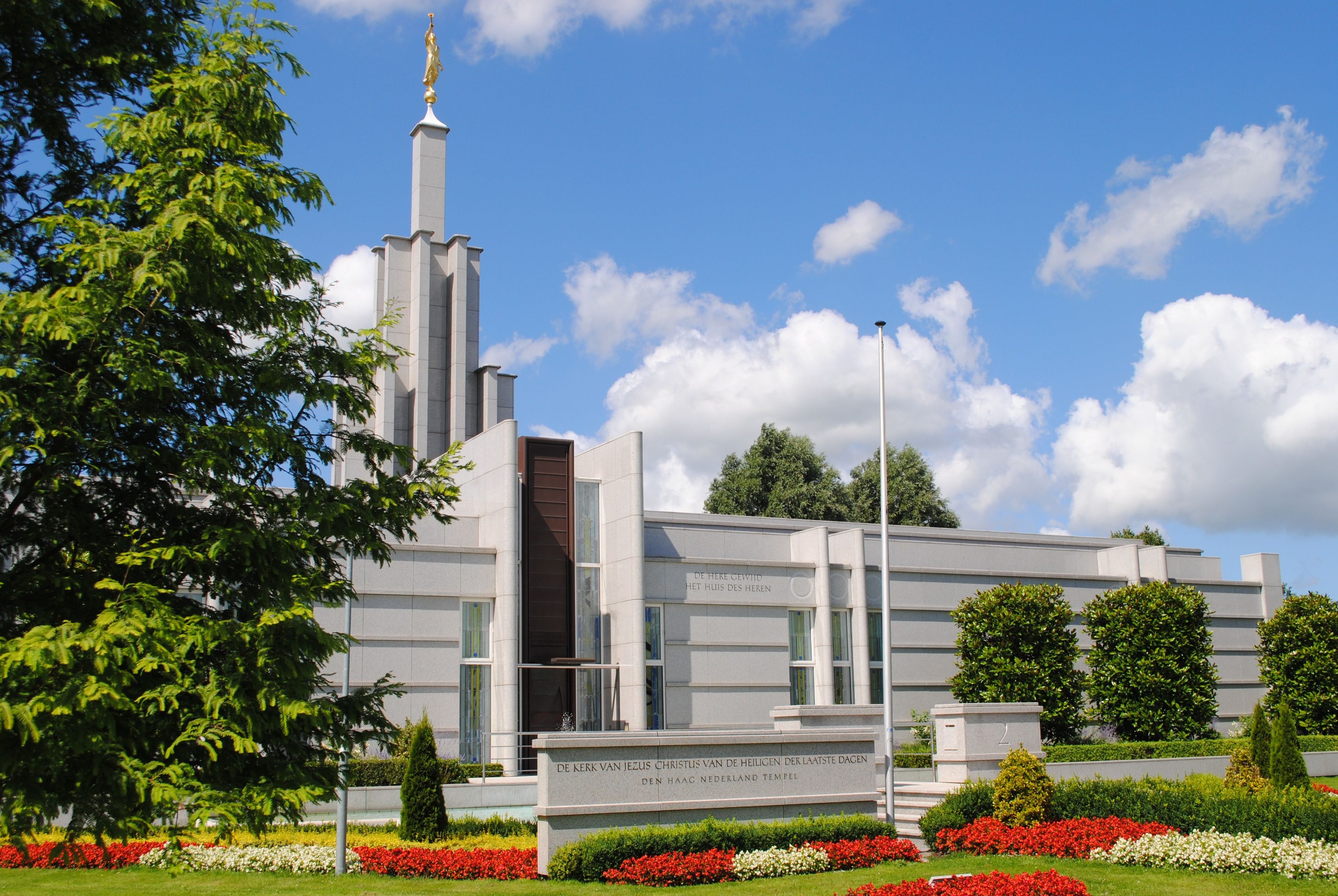 The Hague Netherlands Temple, with the name sign, scenery, and entrance.