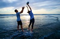 young adults catching ball