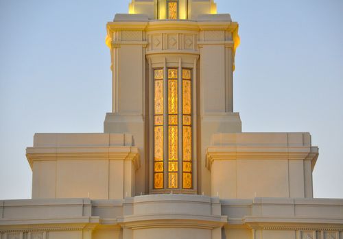 A view of the window on the spire of the Payson Utah Temple in the evening.