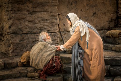 An elderly man sitting down by the pool of Bethesda while Christ stretches out His hand to heal him.