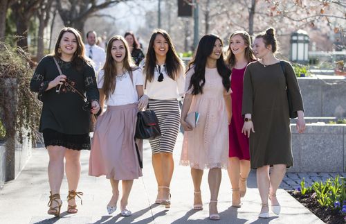Young adult women walking at general conference