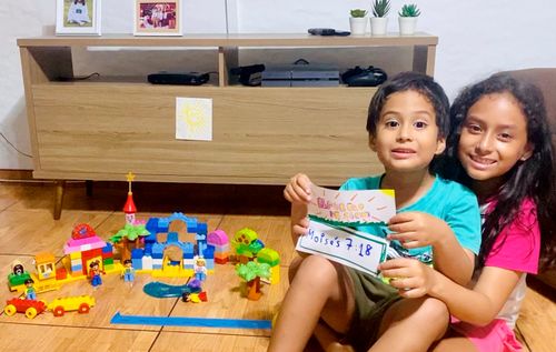 Boy and girl sitting next to plastic blocks