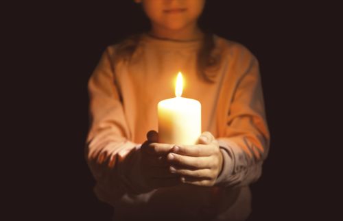girl holding a candle