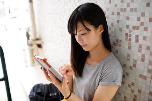 young woman looking at tablet