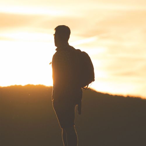 man gazing at a sunset