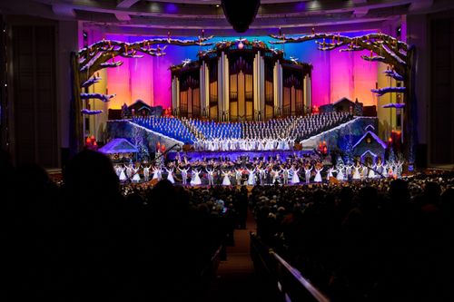 A scene from the 2010 Christmas concert with the Mormon Tabernacle Choir singing in the back and dancers in the front.