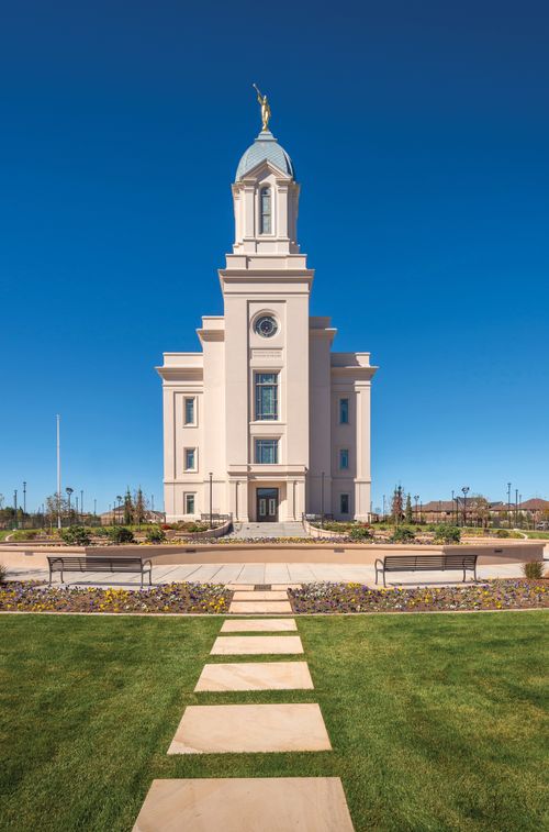 The exterior of the Cedar City Utah Temple, showing the grounds and the path leading up to the front entrance.