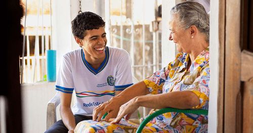 young man and older woman laughing together