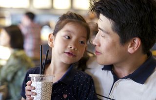 Father spending time with daughter while drinking smoothies.