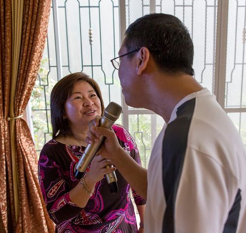 man and woman singing