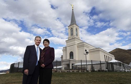 Elder and Sister Bednar standing in front of the temple