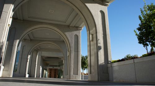 The arched path on the Mount Timpanogos Utah Temple leading to one of the main entrances, which is seen in the distance.