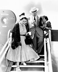 Ezra Taft Benson and his wife getting off an airplane.