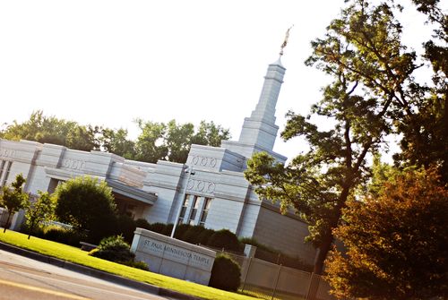A partial view of the front of the St. Paul Minnesota Temple, including the spire and temple name sign.