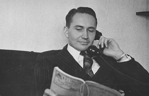 L. Tom Perry holding a phone.