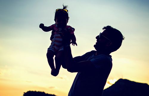 father holding a baby