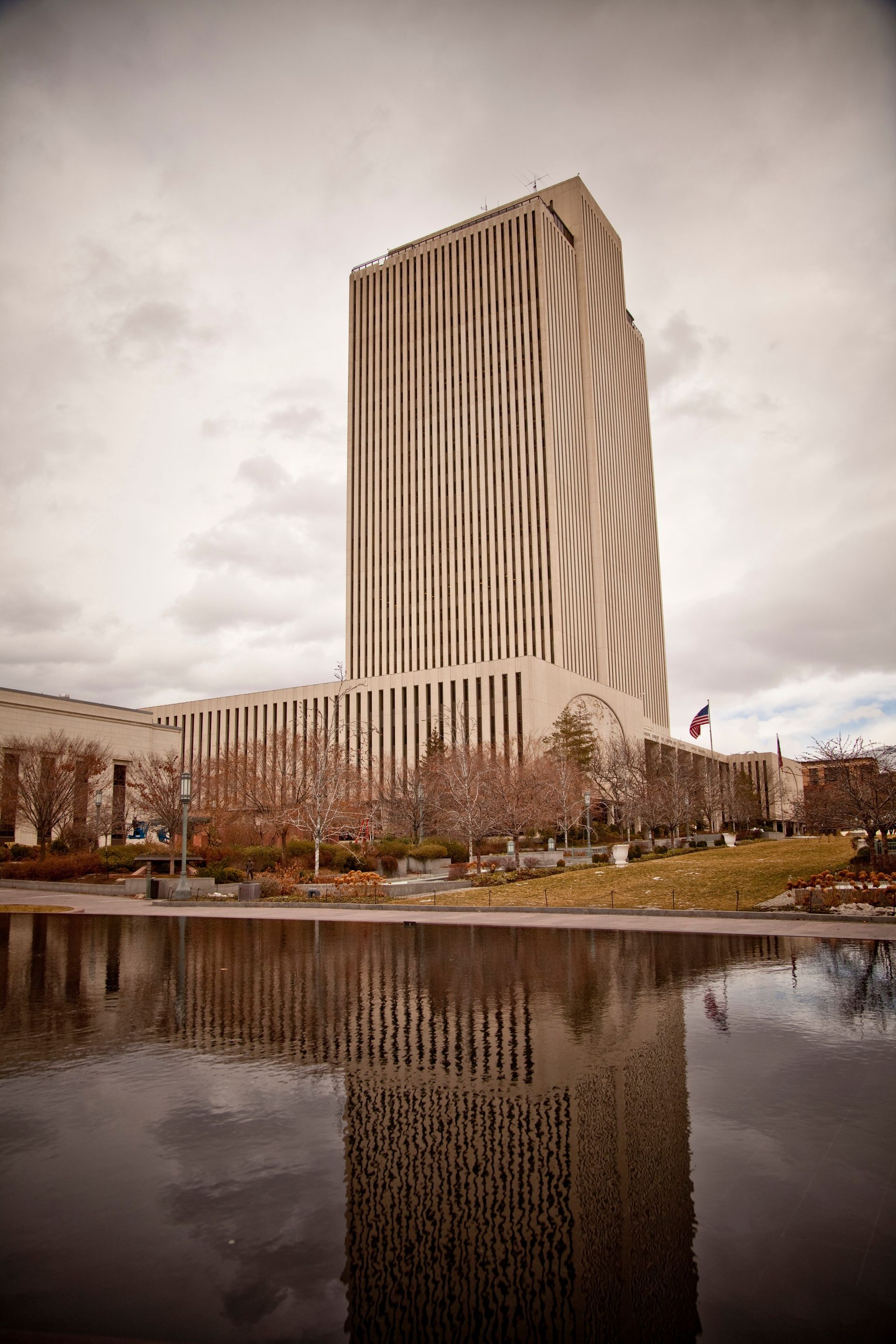 A sepia-toned image of the Church Office Building showing in the reflection pool.  