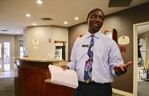 man talking while holding papers