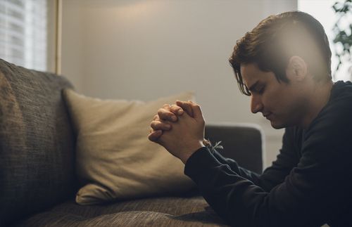 young adult man praying