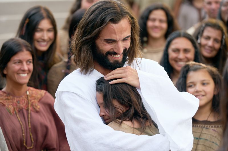 Jesus Christ embraces a boy who was lame that he healed while ministering in the Americas. 