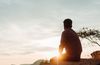 photograph of young man looking into sunset