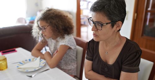 Marta and mother sitting at a table