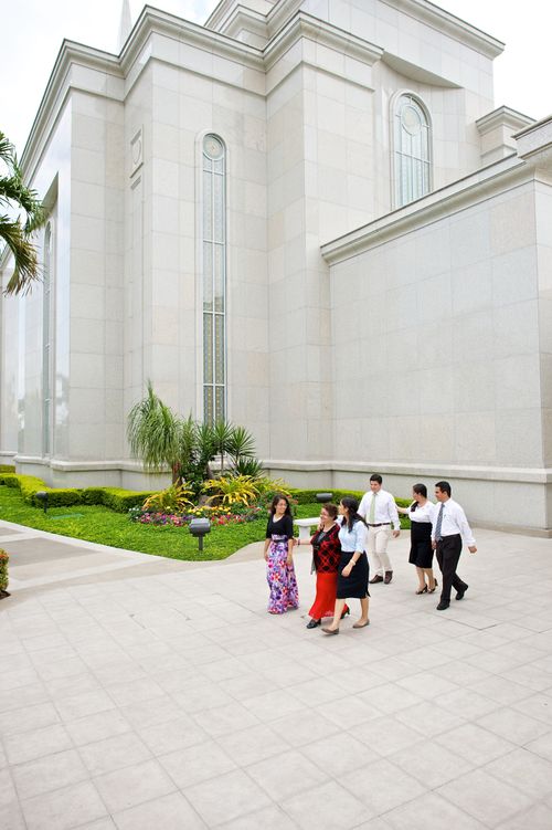 A group of four women and two men walking away from the Guayaquil Ecuador Temple.