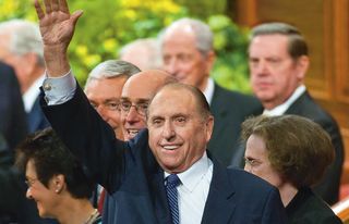 Thomas S. Monson waving in Conference Center