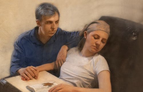 man sitting next to his sleeping wife