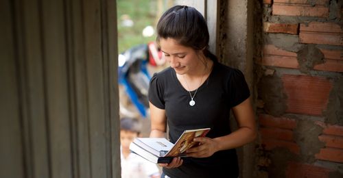 young woman reading Preach My Gospel