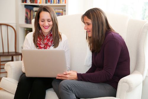 two women looking at laptop