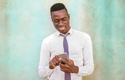 young adult man using phone