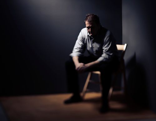 A man sitting in the dark.