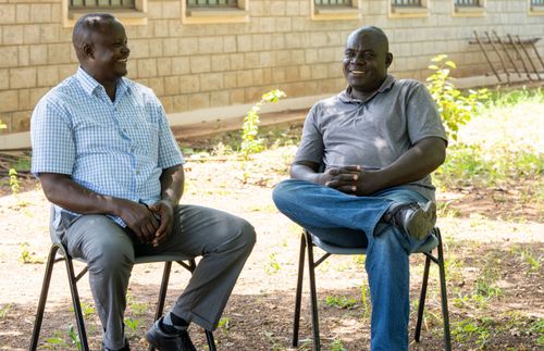 two men sitting together