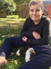 Photo of child with guinea pigs