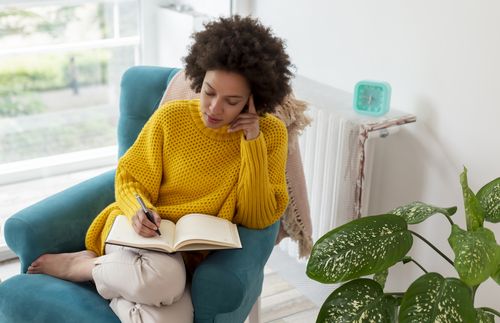 woman writing in a journal