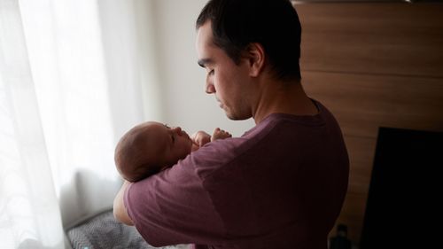 father holding an infant child