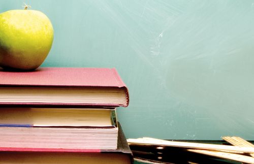 A stack of books with an apple on top.