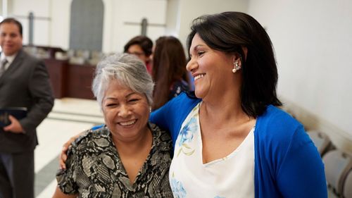 women conversing together at church