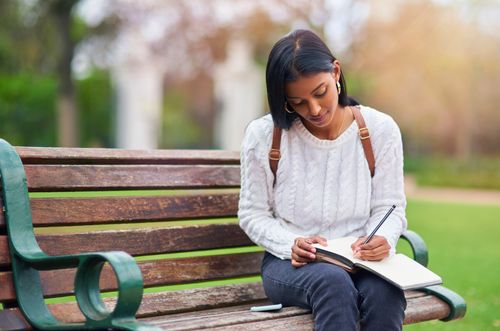 girl writing in notebook