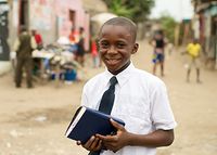 Portraits of child male holding scriptures in Congo