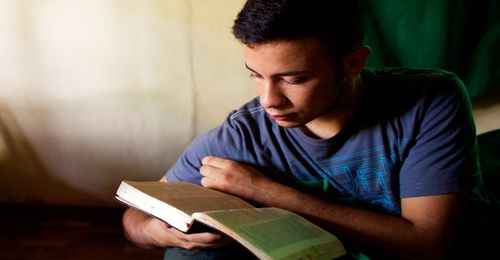 young man studying the scriptures