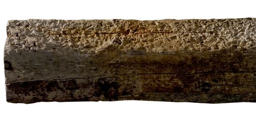 An old hewn oak beam or post photographed against a white background. (vert)